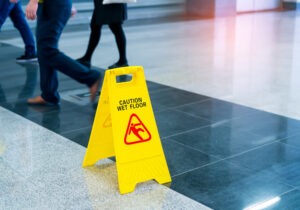 People Walking By Caution Wet Floor Sign