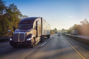 black truck on the road at sunrise