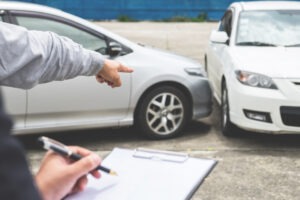 insurance agent documenting car damage