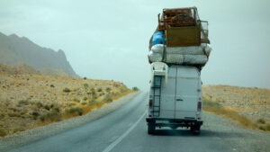 overloaded van driving down the street