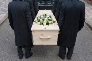 pallbearers holding casket