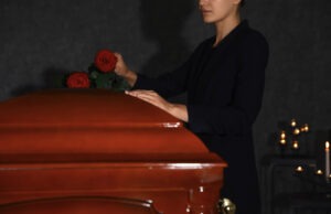 woman-putting-roses-on-a-casket