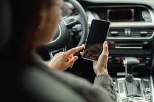 businesswoman using mobile phone while sitting in a car