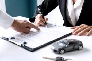 client-signing-car-insurance-documents