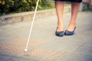 woman-using-cane-on-sidewalk