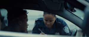 black cop giving black man a ticket