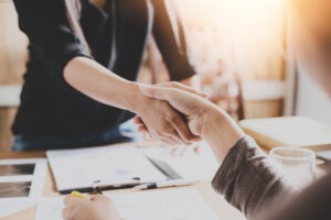 people shaking hands over settlement