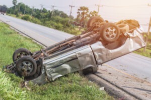 rolled-over silver crunched-up car