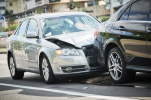 silver car hitting black car