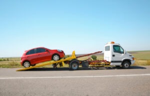 tow truck with red car on back