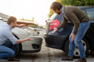 two men arguing after car accident