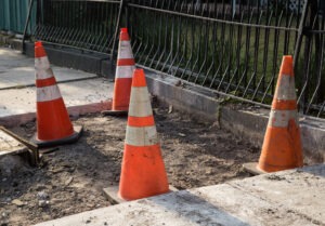 bad sidewalk with cones