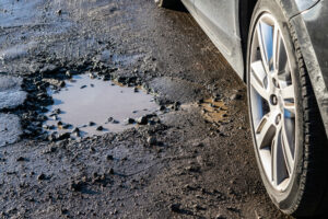 car wheel near pothole