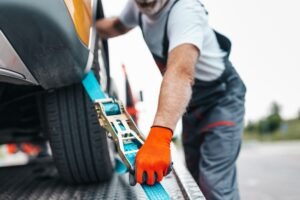 tow truck driver loading car