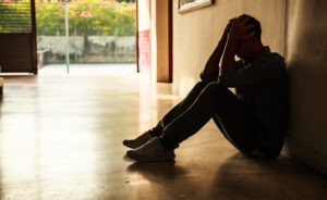 stressed man sitting in the dark