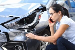 woman calling insurance over a crash