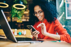 woman happily checking her bank account balance