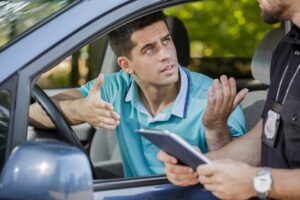 young driver arguing with traffic officer