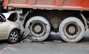 truck accident on road with passenger car