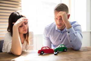 anguished couple looking at toy cars