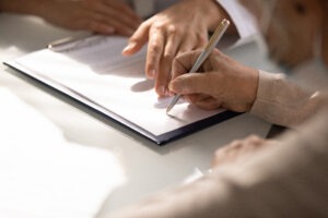 person-signing-paperwork