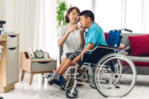 woman feeding son in wheelchair