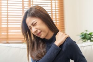 asian woman with shoulder pain