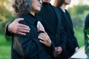 family comforting each other at a funeral