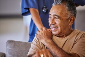 older black nursing home patient holding nurse hand