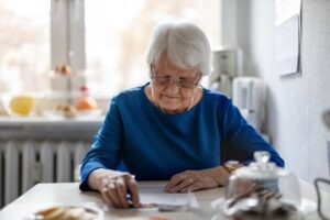 older woman filling out financial papers