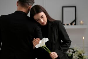 woman mourning with a lily